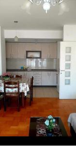 a kitchen with a table and a dining room at Sunny Place in Ohrid