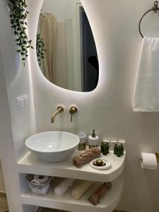 a bathroom with a sink and a mirror at Camelia luxury apartment in Karistos