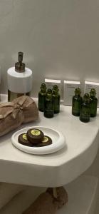 a counter with green jars and a plate of food at Camelia luxury apartment in Karistos