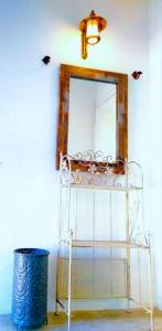 a room with a mirror and a white chair at Apartment Mediterraneo Blue Sky in Perast