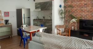 a kitchen with a couch and a table in a room at Apto aconchegante e familiar em BC in Balneário Camboriú