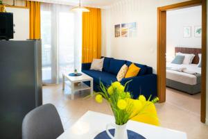 a living room with a blue couch and a bed at Cozy Home Santa Marina in Sozopol +44 photos