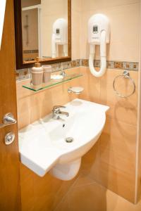 a bathroom with a white sink and a mirror at Cozy Home Santa Marina in Sozopol