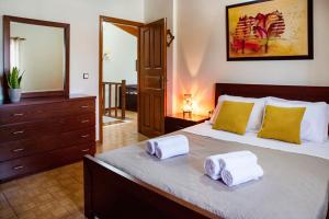 a bedroom with a large bed with towels on it at Serenità in Lefkimmi