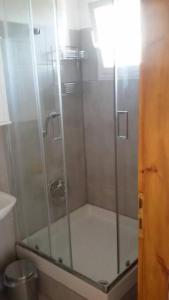 a shower with a glass door in a bathroom at ΠΑΝΟΡΑΜΑ in Aigáni