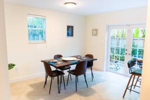 a dining room with a table and chairs at Coconut Grove Hidden Sanctuary Townhouse in Miami