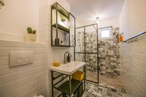 a bathroom with a sink and a shower at Kitty Sunflower Apartment in Alba Iulia