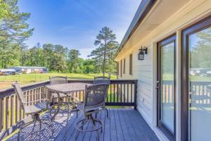 a deck with a table and chairs on a house at Sleeps 8, Lake Lanier Hidden Gem in Buford