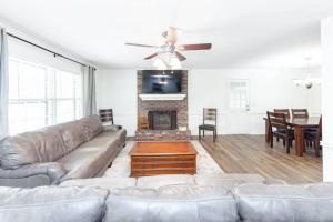 a living room with a couch and a fireplace at Sleeps 8, Lake Lanier Hidden Gem in Buford