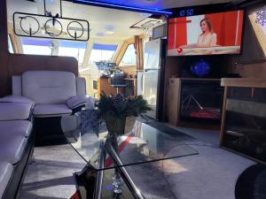 a living room with a couch and a tv at COZY CONDO OCEAN 3xDECK YACHT in Brooklyn