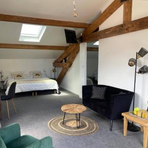 a living room with a bed and a couch at Ezz'Hotel Canet in Canet-en-Roussillon