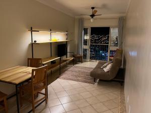 a living room with a table and a couch at RelaxRP in Ribeirão Preto