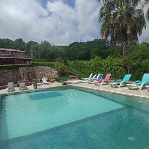 - une piscine avec des chaises longues et des chaises dans l'établissement Tenuta del Bifan, à Policastro Bussentino