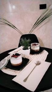 a table with a black table cloth with a tray of food at Suite Whiteflower in Bari