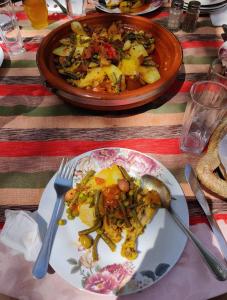 a plate of food on a table with a bowl of food at Auberge Le Mouflon in Ouirgane