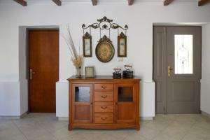 a room with a wooden cabinet and a door at Villa Antigoni in Megáli Vrísi