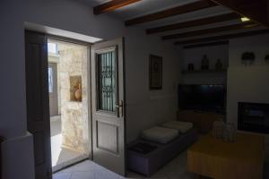 a living room with a door and a couch at Villa Antigoni in Megáli Vrísi