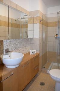 a bathroom with a sink and a toilet and a shower at Villa Antigoni in Megáli Vrísi