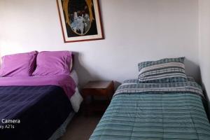 Un pat sau paturi într-o cameră la Preciosa casa de descanso a 10 min de Villa de Leyva