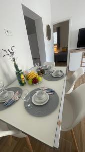a white table with plates and glasses on it at Rocco in Dolac