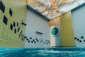 a pool with water spraying out of a building at Gran Hotel Don Manuel in Cáceres