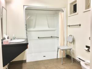 a bathroom with a shower and a sink at Naramata Centre in Naramata