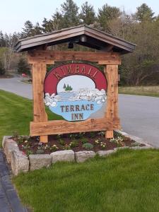 a sign for a farmers inn on the side of a road at Kimball Terrace Inn in Northeast Harbor