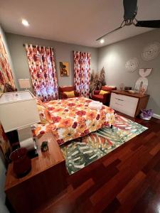 a bedroom with a large bed with a colorful comforter at Retro-inspired Content House In Patterson Park in Baltimore