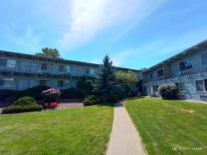 a walkway in front of an apartment building at Cocusa Motel in Burlington