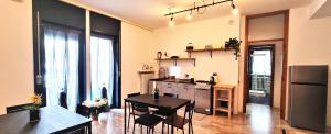 a kitchen with a table and a dining room at Guesthouse Tree Rooms Industrial in Bergamo