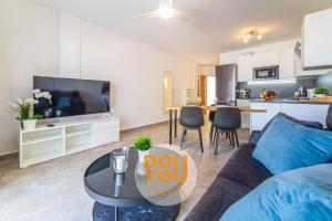 a living room with a couch and a table at Holiday Apartments Oasis in Los Cristianos