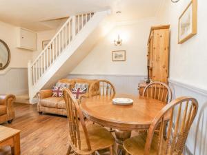 a living room with a table and a couch at Beech Cottage in Ulverston +17 photos