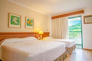 Un pat sau paturi într-o cameră la Hotel Monte Real