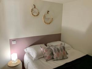a bedroom with a bed and two mirrors on the wall at Suite Côté Hygge ALBI centre in Albi +4 photos