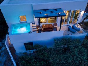 an aerial view of a house with a swimming pool at Villa Mare Syros in Finikas
