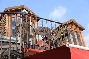 a balcony of a house with a slide at Tatin - Hotel & Café in Mtskheta in Mtskheta