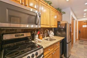 a kitchen with a stove and a sink at Riverbend Centennial Run Condo: Ski In/Out in Breckenridge