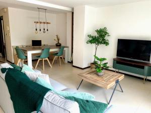 a living room with a couch and a table at la trottinette vakantiehuis voor 5 tot 11 gasten vlakbij de Semois in Florenville