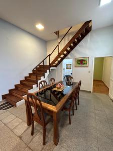 a dining room with a table and a staircase at Departamento Completo, 3 habitaciones. Excelente ubicación in Asuncion