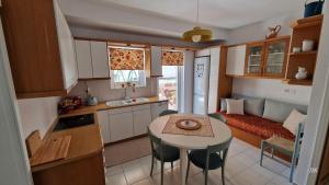 Two bedroom flat near airport في باليني: مطبخ صغير وغرفة معيشة مع طاولة وسرير