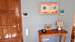 a room with a door and a table with a lamp at Two bedroom flat near airport in Pallíni