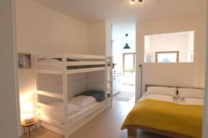 a bedroom with two bunk beds and a yellow bed at Family Ranch Urlaub am Pferdehof 