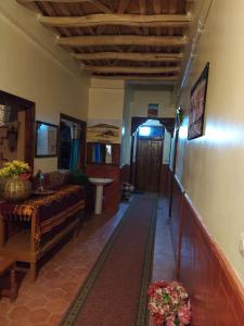 a hallway of a house with a couch and a table at Kasbah La Famille Berbère in Boumalne Dades