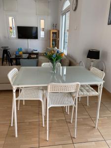 a white dining table and chairs in a living room at Villa Diana - 200 meters from Kapparis, Fireman's Beach in Paralimni