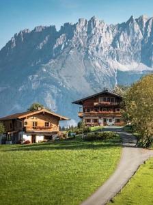 a house and a road in front of a mountain at Hof Hintererb in Kitzbühel