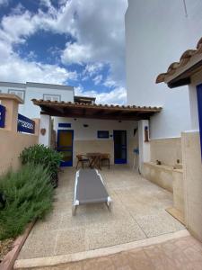 a patio with a table and a bench at Apartamentos Mallorca SL in Cala Millor