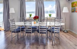 a dining room with a white table and chairs at Beautiful Home In Filtvet With Kitchen in Filtvet