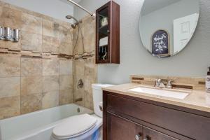 a bathroom with a toilet and a sink and a mirror at Canyon Lake Vacation Rental Less Than half Mi to Water! in Canyon Lake +26 photos