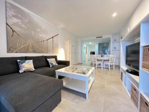 a living room with a couch and a table at Ocean View Apartment in Arenales del Sol