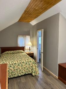 a bedroom with a bed and a window at Doray Motel Lake George in Lake George